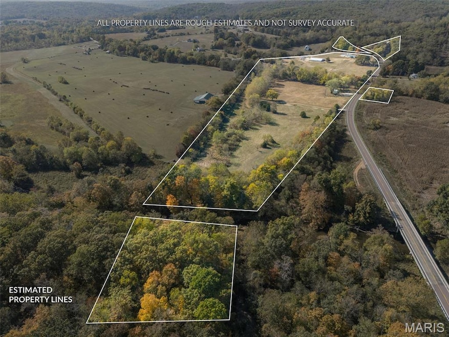 Overview of rural landscape with property boundaries highlighted and a forest