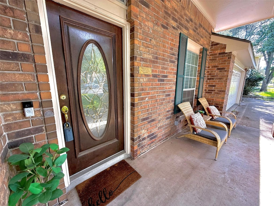 View of exterior entry with brick siding, an atta