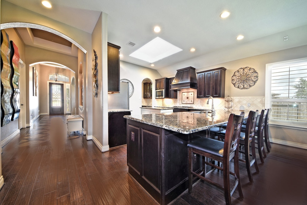 Amazing Custom Home has over $83.000 of Upgrades & you can tell! Some of the main options are;  Stunning 8 Foot Doors throughout, Large Base Boards, Crown Molding, Stainless Steel Built In Appliances, Wine Fridge, Washer, Dryer, Stainless Refrigerator, Plantation Shutters, Rain Shower Head, 4 Side Brick, Gutters, Security System, Gas line on patio, Beautiful Facets, Water Softer System, Sprinkler System, Stone Fireplace, Wood Floors, Kentmore Cabinets w/Vent Hood, Limestone Bathrooms Counters! More