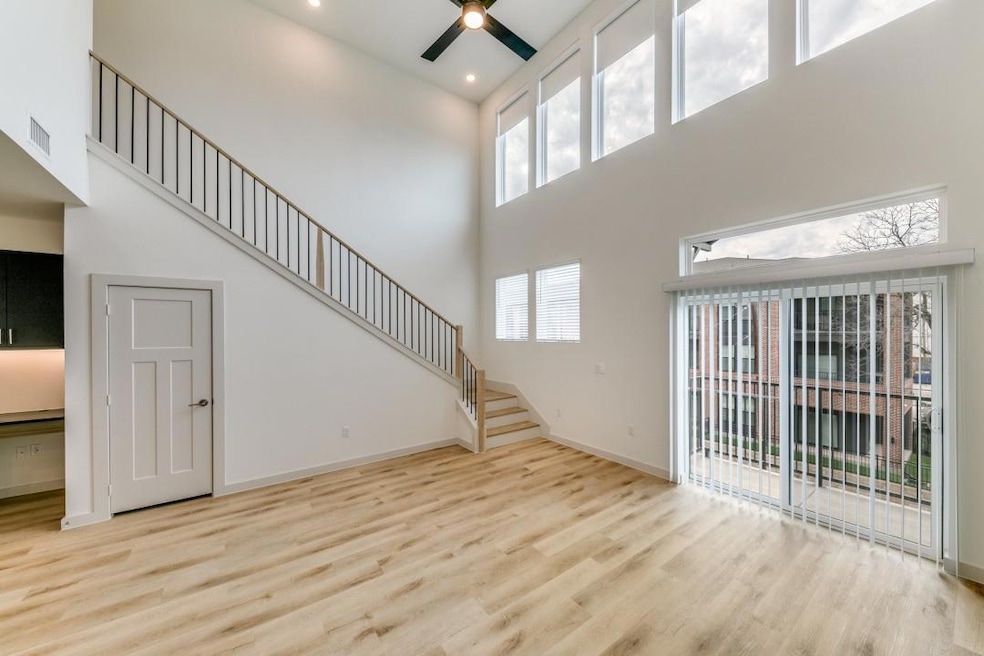 Unfurnished living room featuring stairway, wood f