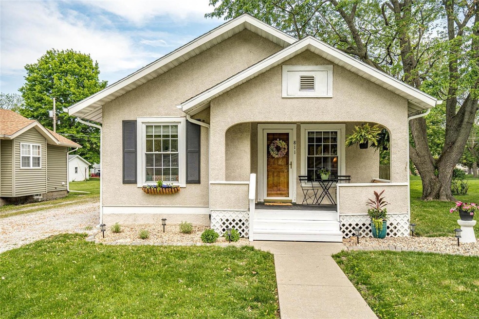 Welcoming front porch with room for chairs and a s