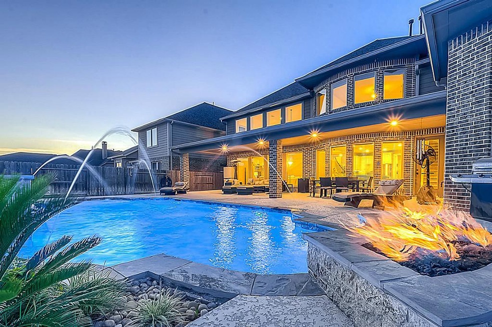 This exquisite Perry home boasts many upgrades. Enjoy cooling off in your pool and on those cool fall nights enjoy the fire pit while watching the game.