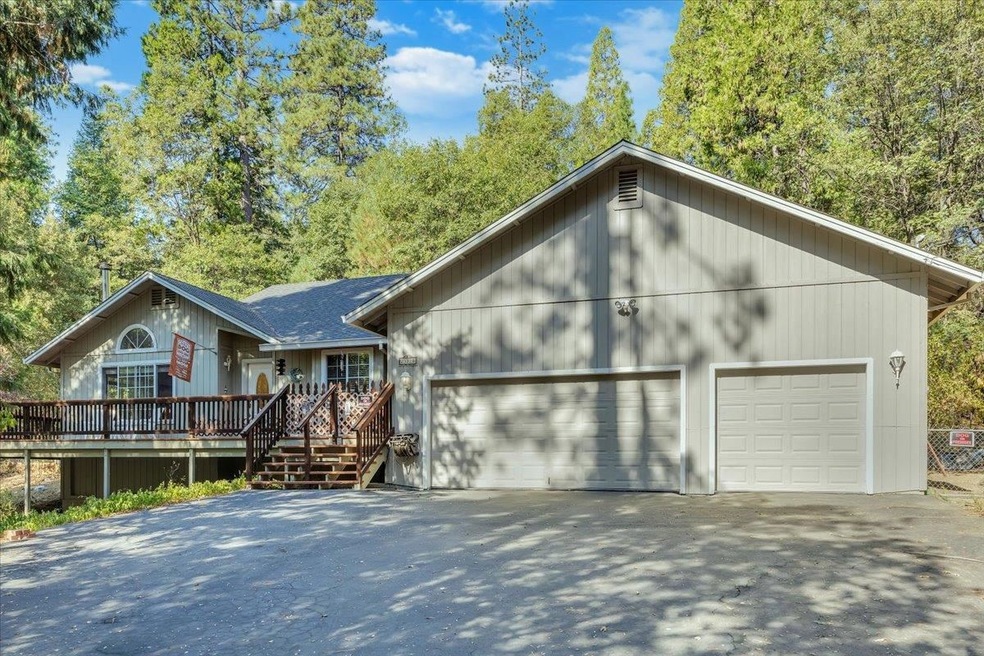 Ranch-style house with a wooden deck and a garage