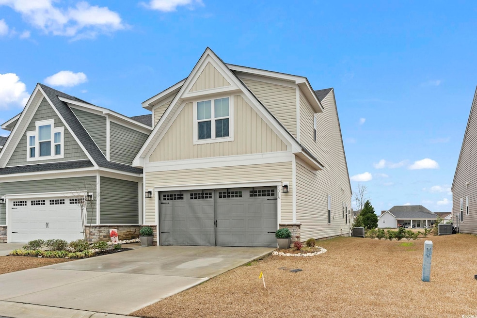 Craftsman house featuring central AC and a garage