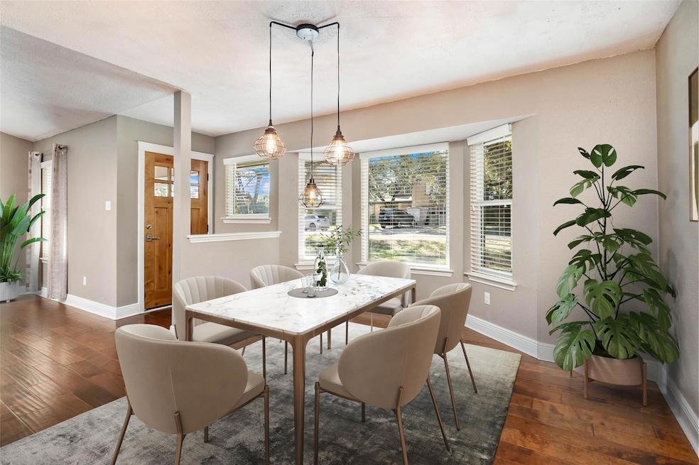Dining room with baseboards and hardwood / wood-s