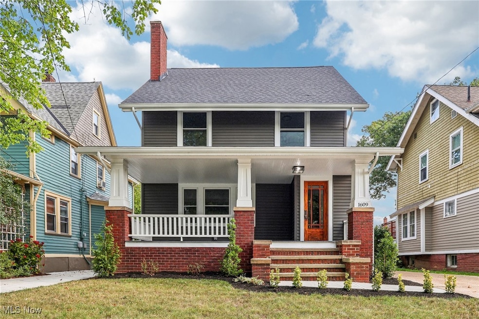 View of front facade with covered porch and a front yard