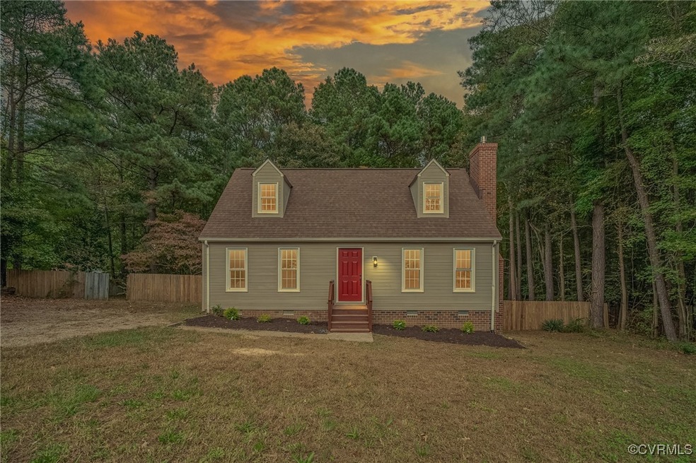 Cape cod house featuring a yard