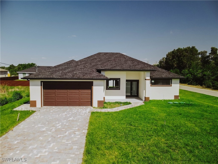 Prairie-style house with a front yard, a garage, s