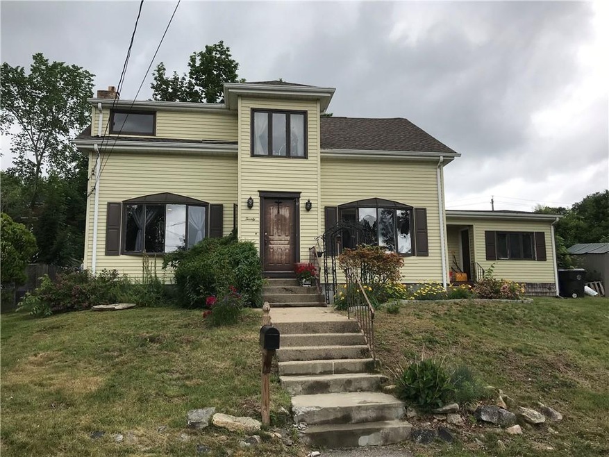 Front of home, 2 bay windows. Second entrance into
