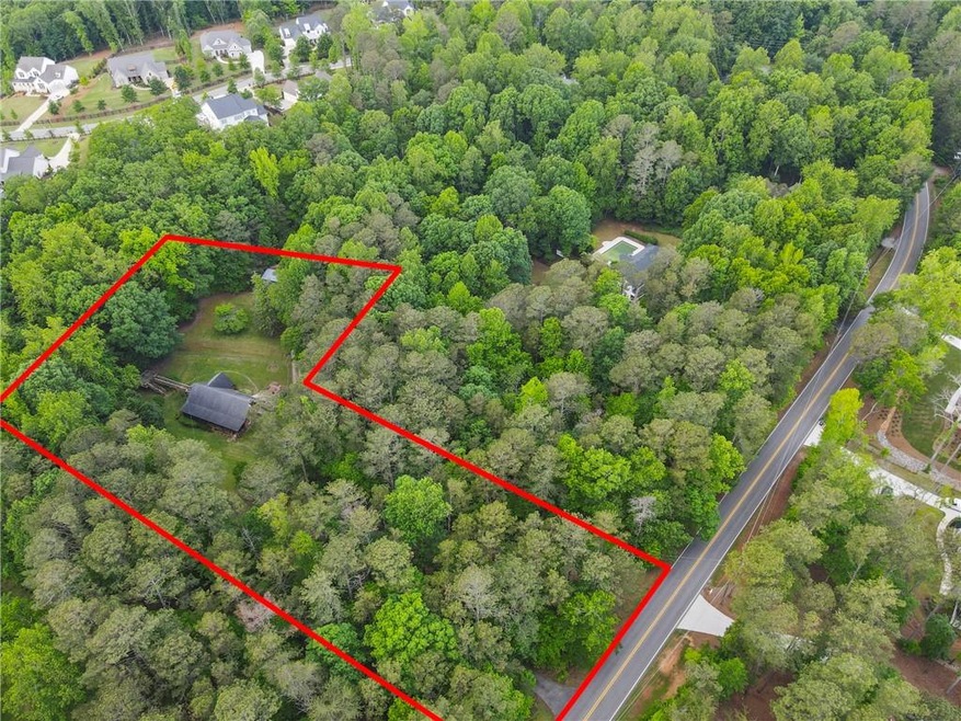 Aerial overview of property's location with property parcel outlined and a forest