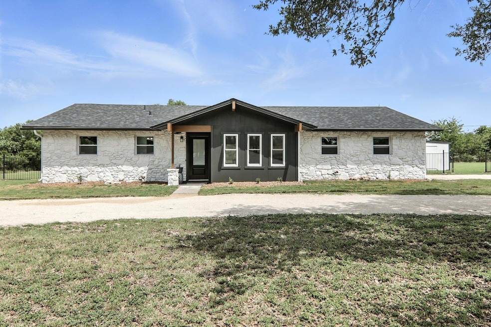 View of front facade with stone siding and roof w