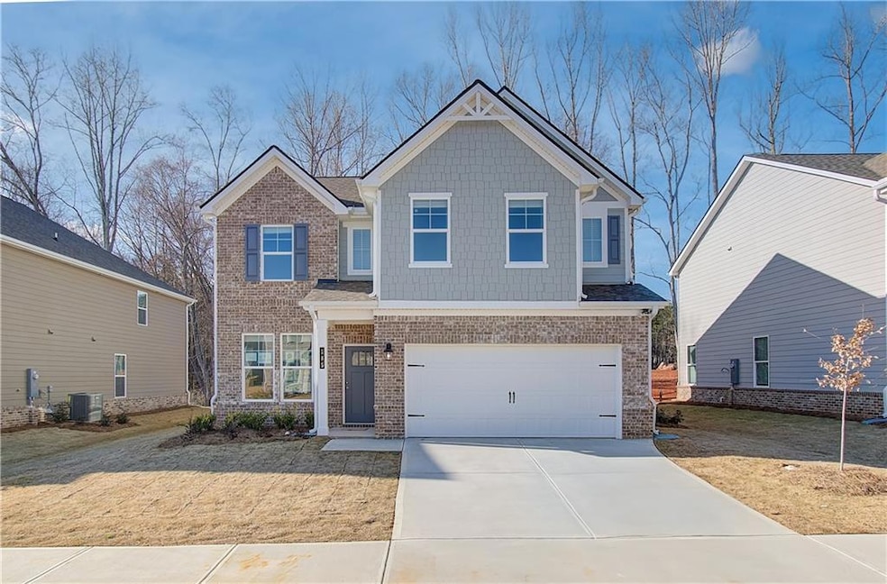 Craftsman-style house featuring a garage and central AC unit