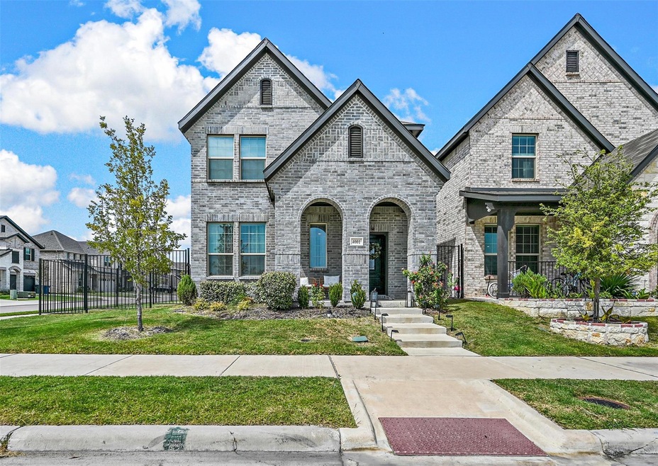 French provincial home with a front lawn