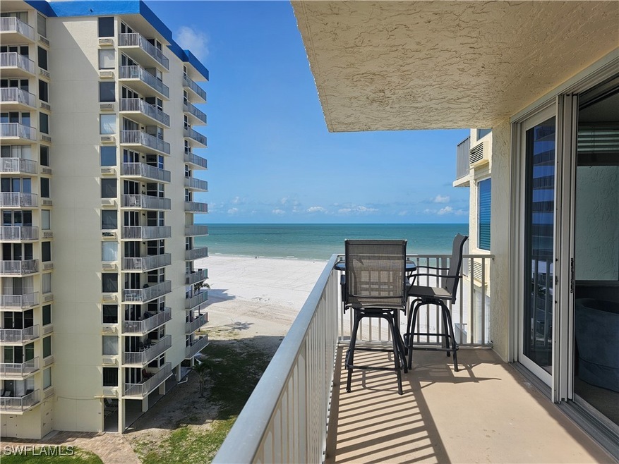 Balcony featuring views of gulf and beach as well