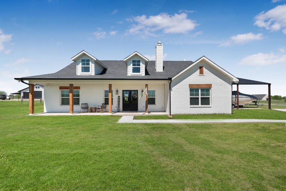 Front of house with a huge yard