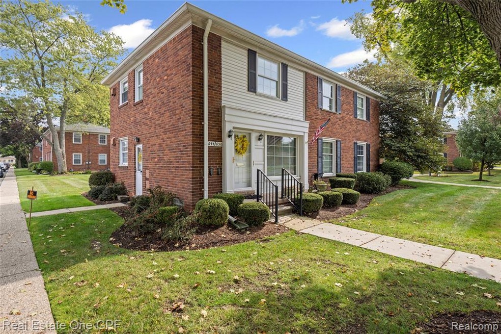 Colonial house featuring a front yard and brick siding