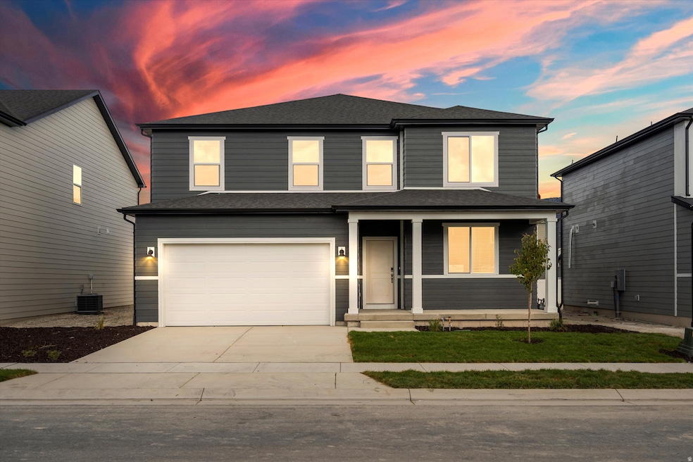 Traditional-style home featuring covered porch, driveway, and roof with shingles