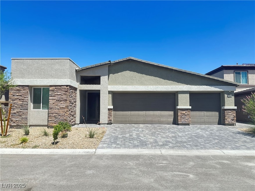 View of front of house with stucco siding, stone s
