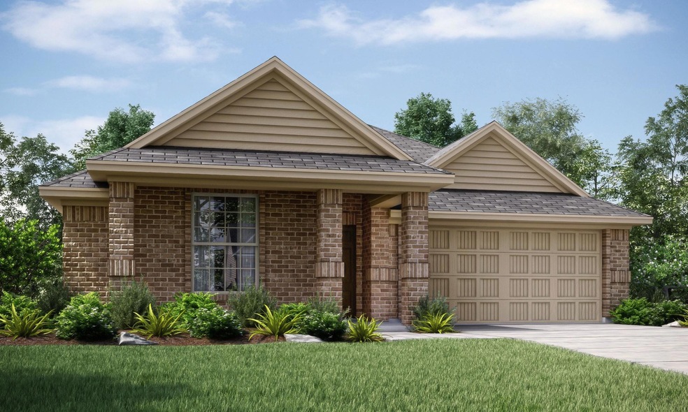 View of front of house with a garage and a front y