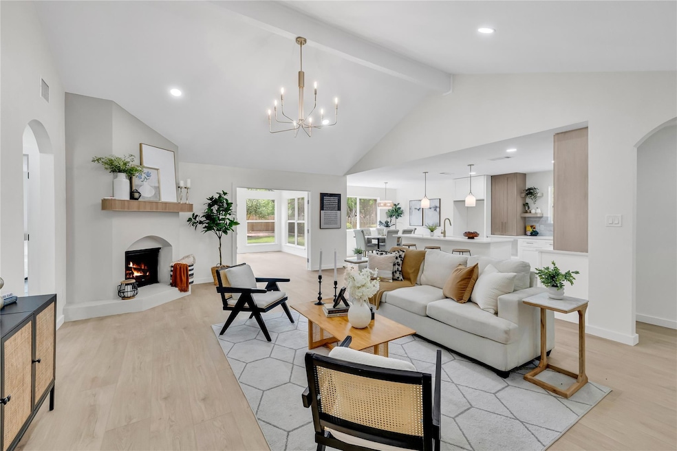 Living area with beam ceiling, light wood finishe