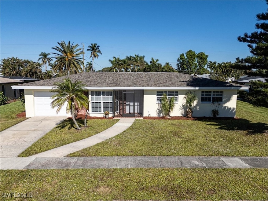 Ranch-style house with a garage and a front lawn