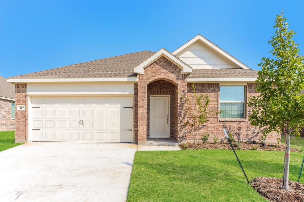 Ranch-style house featuring a front yard and a garage
