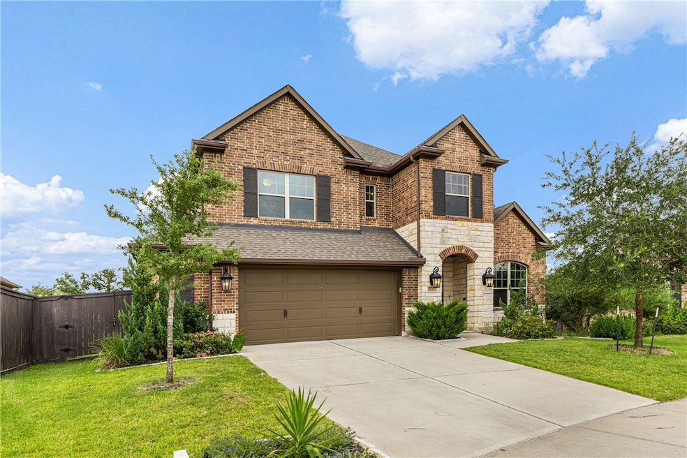 Craftsman inspired home with concrete driveway, a shingled roof, stone siding, an attached garage, and brick siding