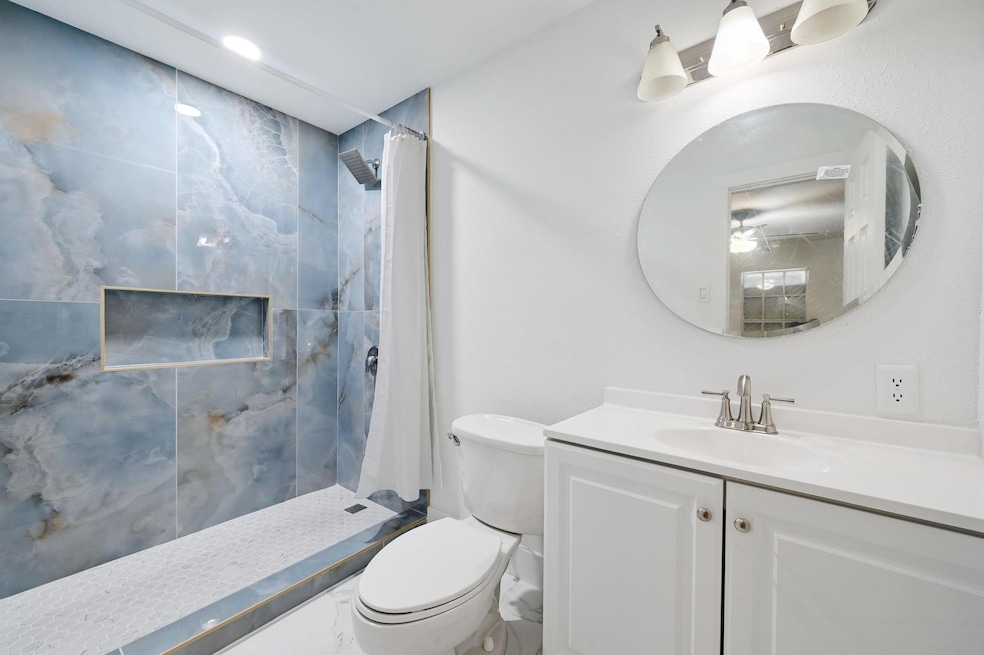 Full bathroom featuring toilet, vanity, and curta