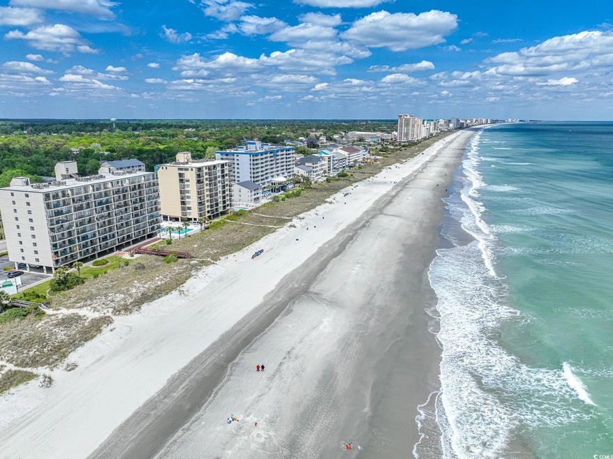 Aerial view featuring a beach view and a water vie