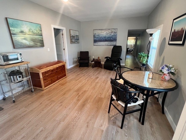 Open family room featuring light wood finished floors and baseboards