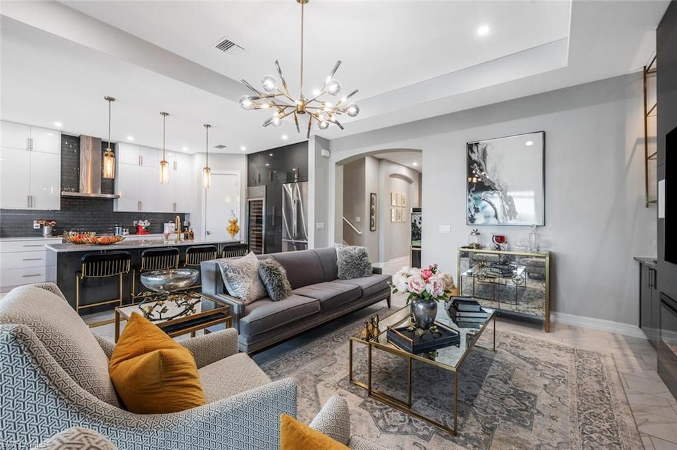 Living room featuring recessed lighting, arched wa