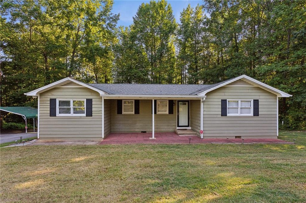 Ranch-style home with a front lawn and a porch