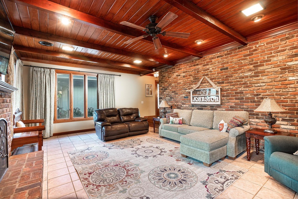 Brick accent wall / large windows look out onto your large back yard