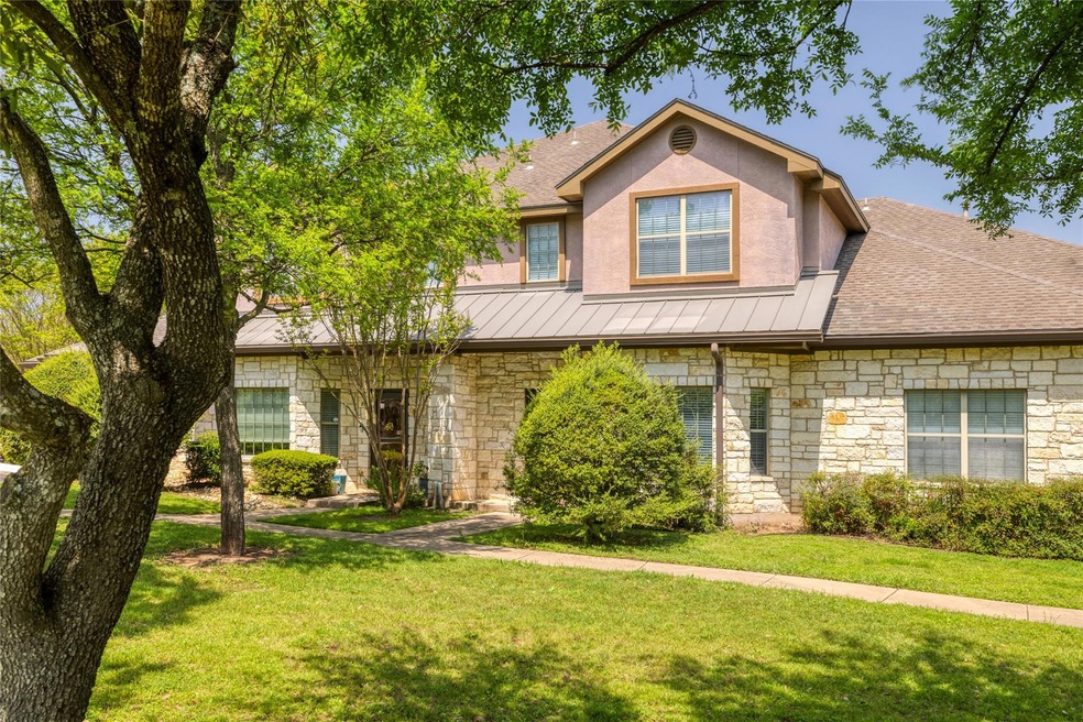 View of front of house with stone siding, a stand