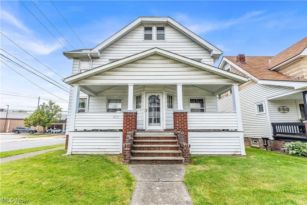 Bungalow with a front lawn and a porch