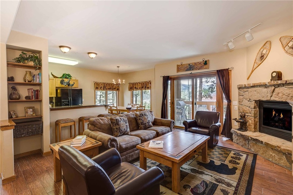 Great room with corner gas fireplace, deck with fi