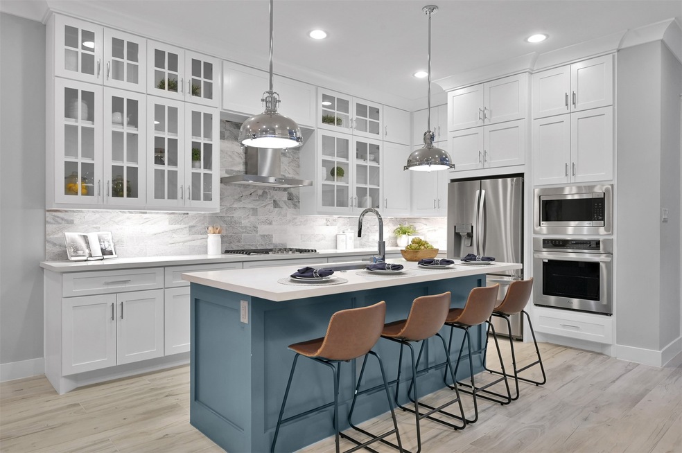 Welcome to a culinary oasis, a beautifully designed kitchen that perfectly marries function and style. To accentuate this bright and airy space, elegant glass cabinets offer subtle visual interest and a perfect display for cherished dishware or collectibles.