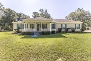 View of front of house featuring covered porch and