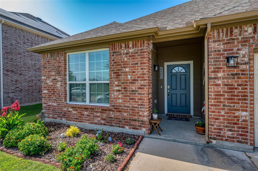 Ranch-style house with a garage, a front lawn, and solar panels
