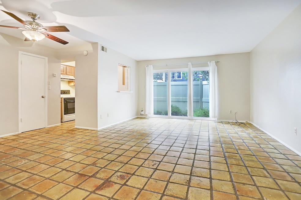 Welcome to this charming home with a spacious living/ dining area and beautiful saltillo flooring.  A private back patio area and large windows allow for plenty of natural light to come in.