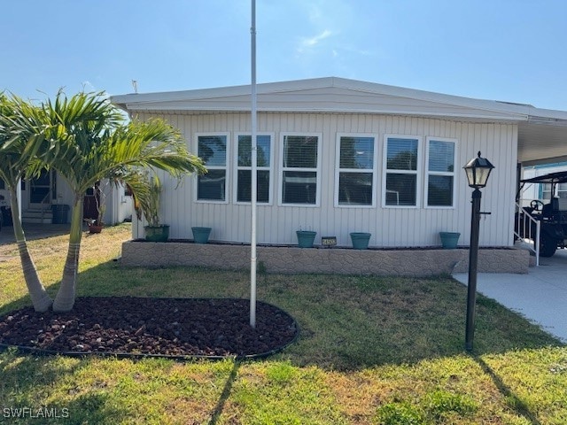 View of front of home with a carport and a front l