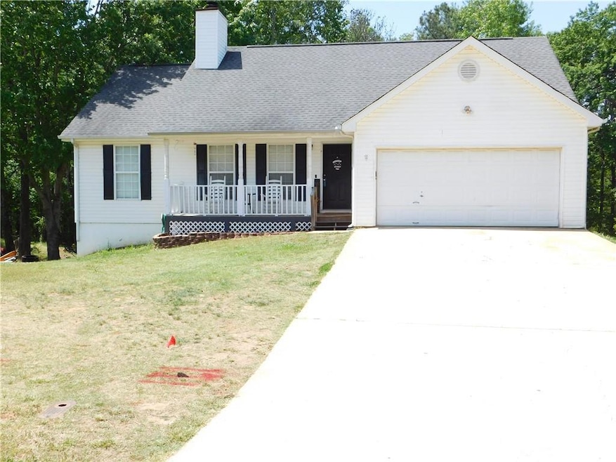 Ranch-style home with concrete driveway, a front l