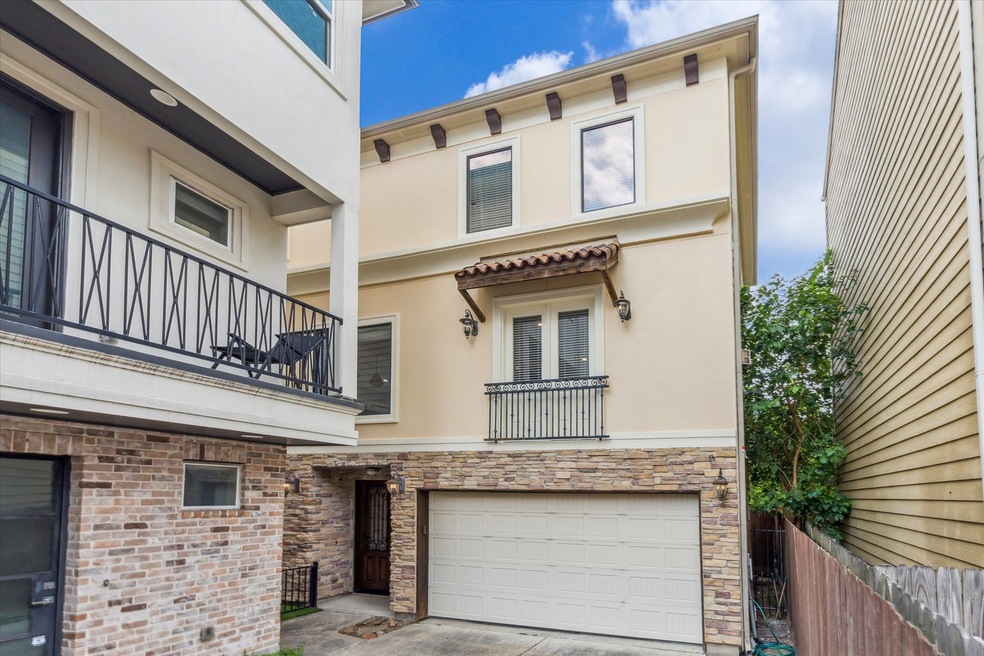 Updated three-story townhouse with a stucco and st