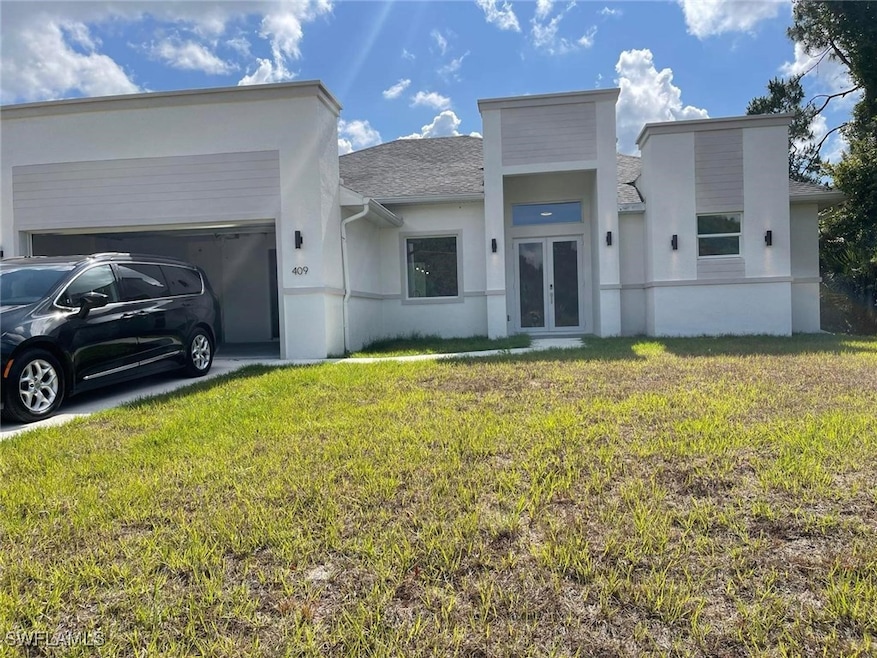 View of front facade with french doors, stucco sid