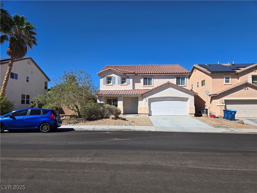 Mediterranean / spanish home featuring driveway, stucco siding, an attached garage, and a tile roof