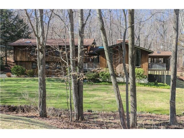 Exterior view set among the woodlands in a cul-de-
