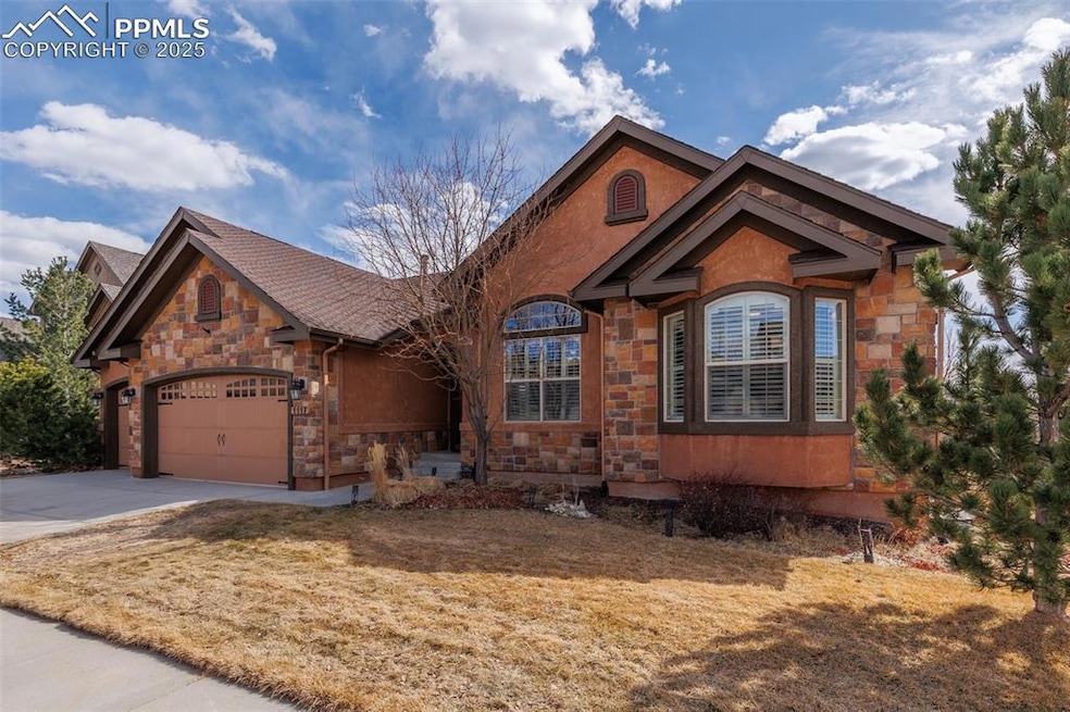View of front of home with concrete driveway, a ga