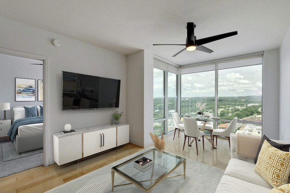 Living area featuring floor to ceiling windows, a
