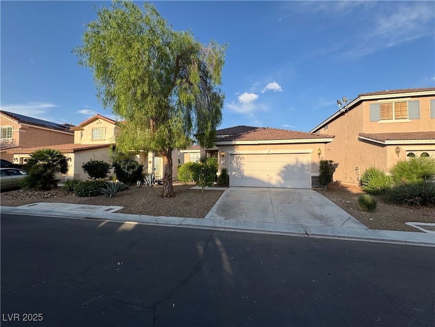 View of front facade with a garage, driveway, stuc