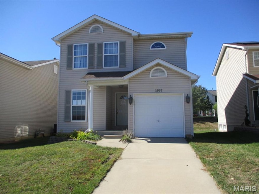 Traditional-style home featuring a front lawn and driveway